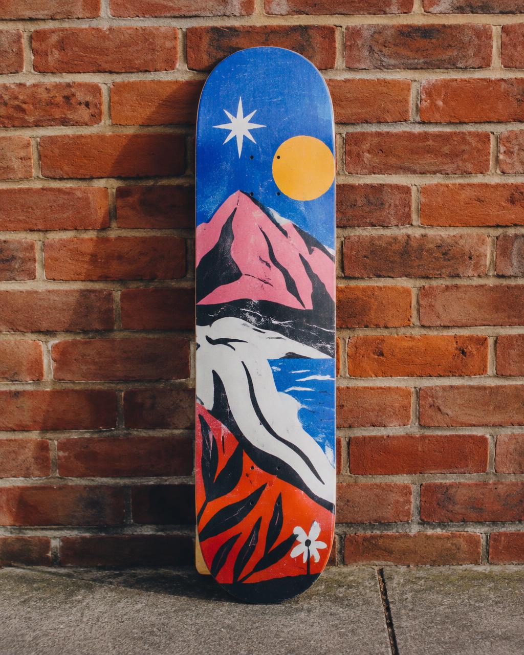 Hand-painted skateboard deck leaning on a brick wall